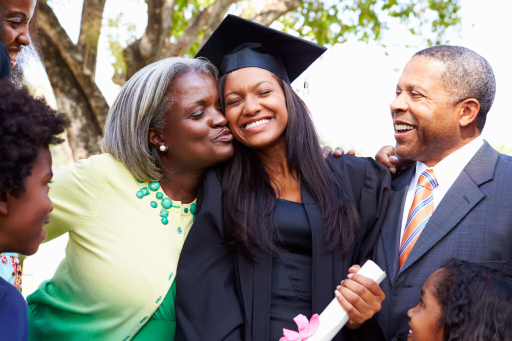 family of four with female graduate in cap and gown