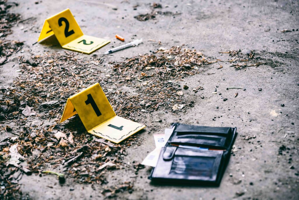 crime scene investigation with yellow marker on the ground
