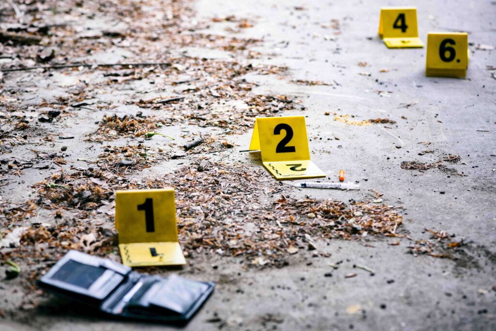 crime scene with yellow number signs and wallet