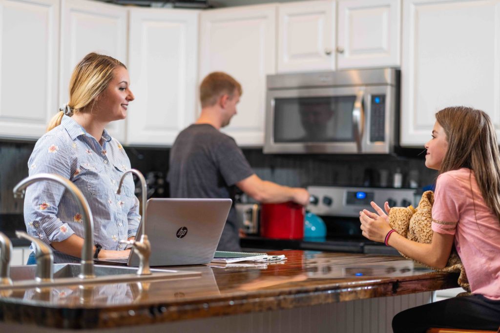 parents in kitchen with daughter