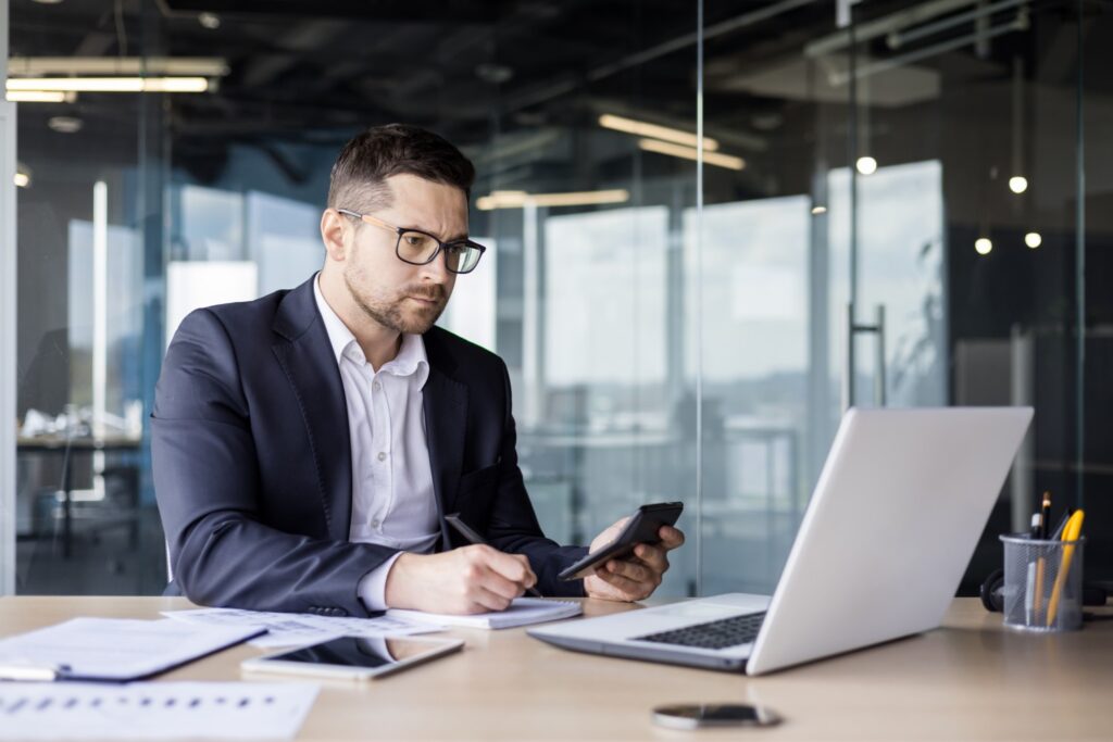 CPA using a calculator and sitting at a desk