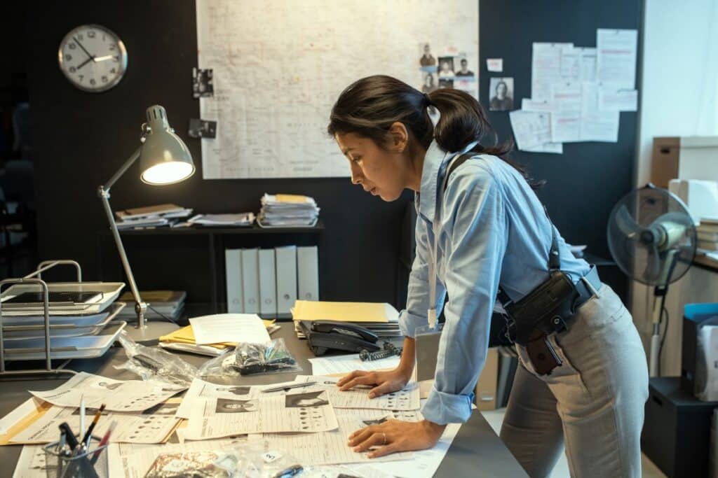 Criminal investigator starting out in her criminal justice career working on a case in her office