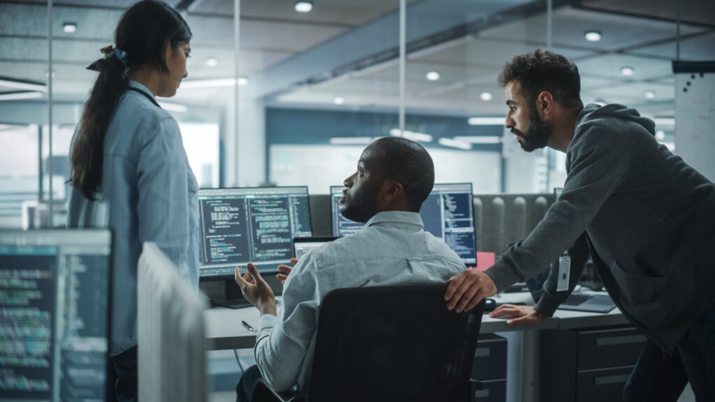 Cybersecurity professionals in an office working on computers