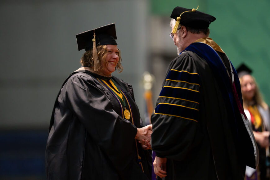 graduate receiving diploma