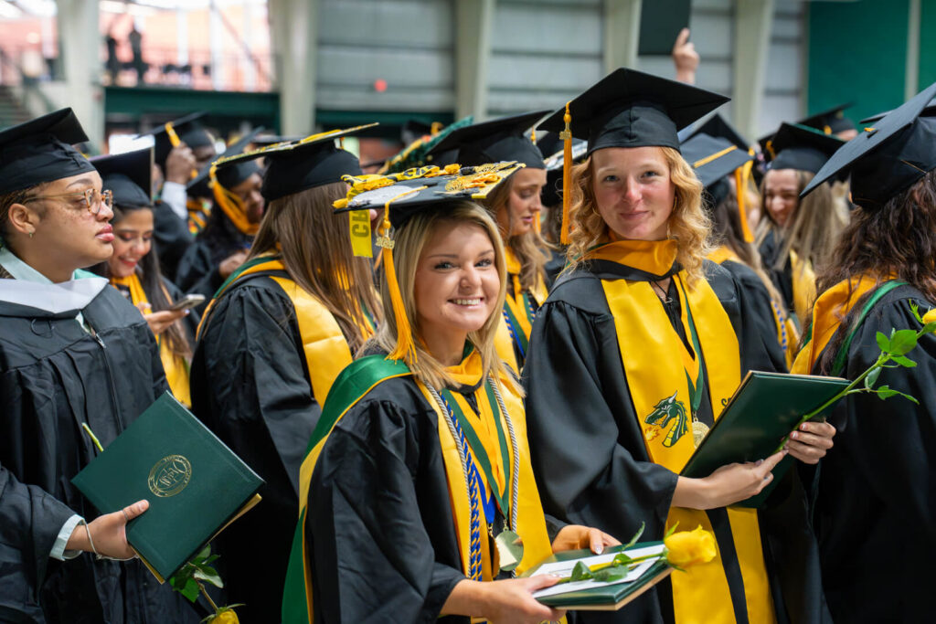 happy graduates in full regalia