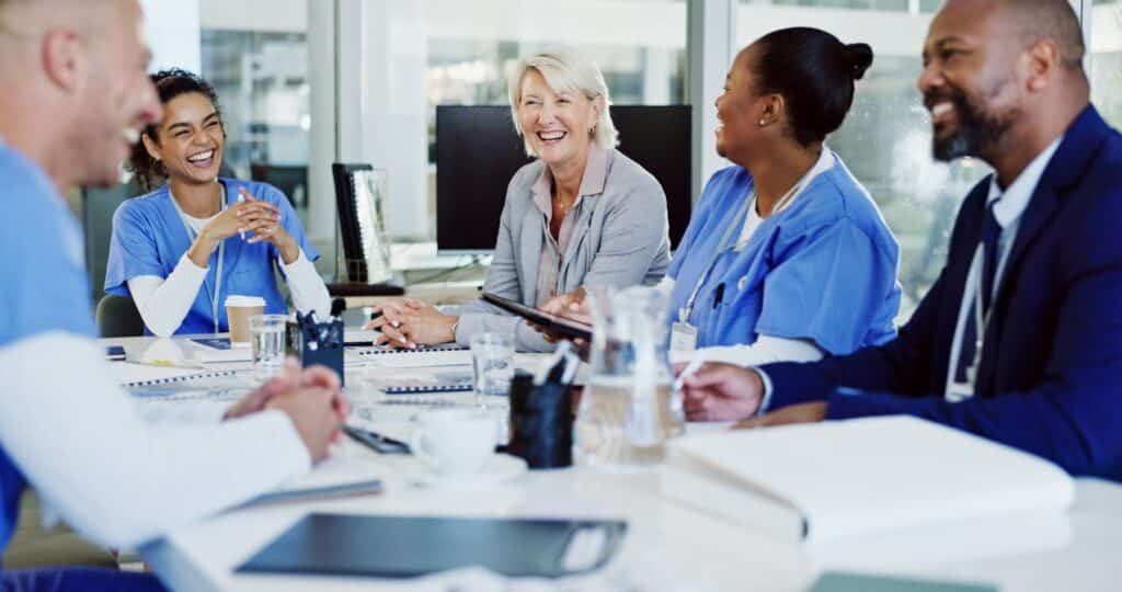 MSN nurses in a boardroom meeting with hospital staff members