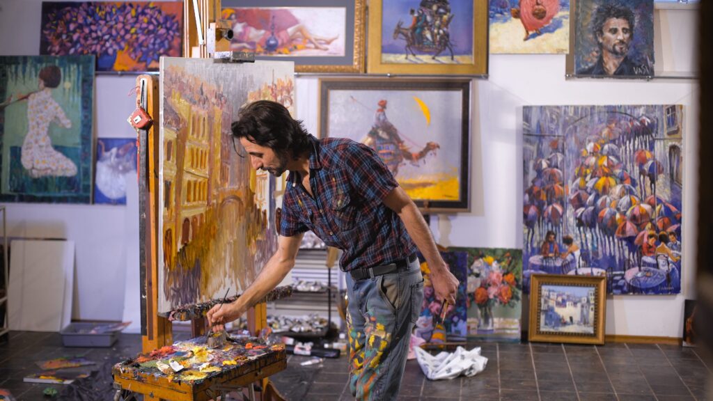 Visual media artist painting in a studio
