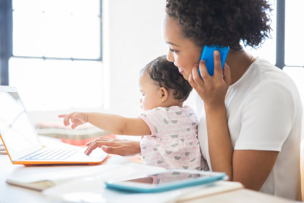 College student experiencing a work life balance with taking college courses online with her baby from home